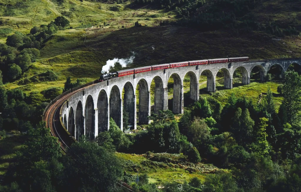 A slow train going through the Scottish mountains