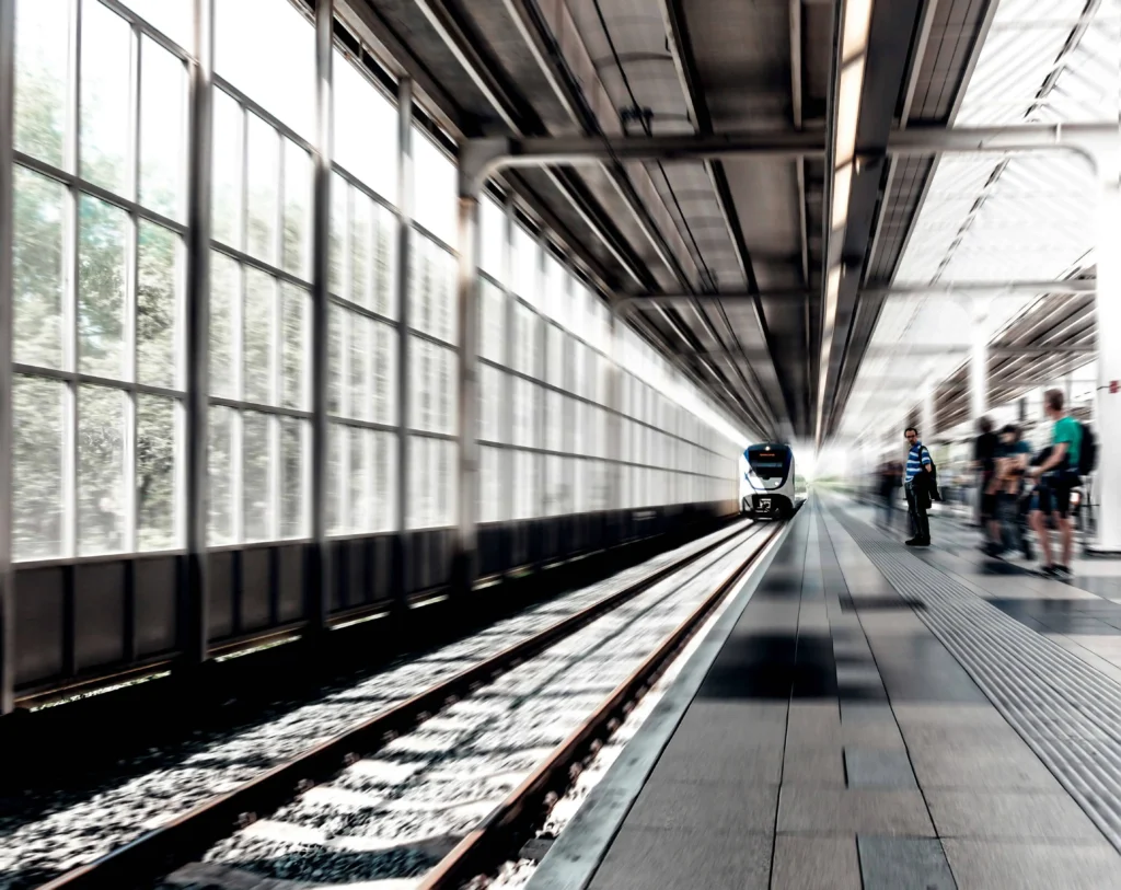 A slow train pulling in to an empty station